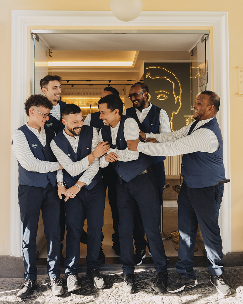 Harmont & Blaine Capri bar staff smiling at the entrance.
