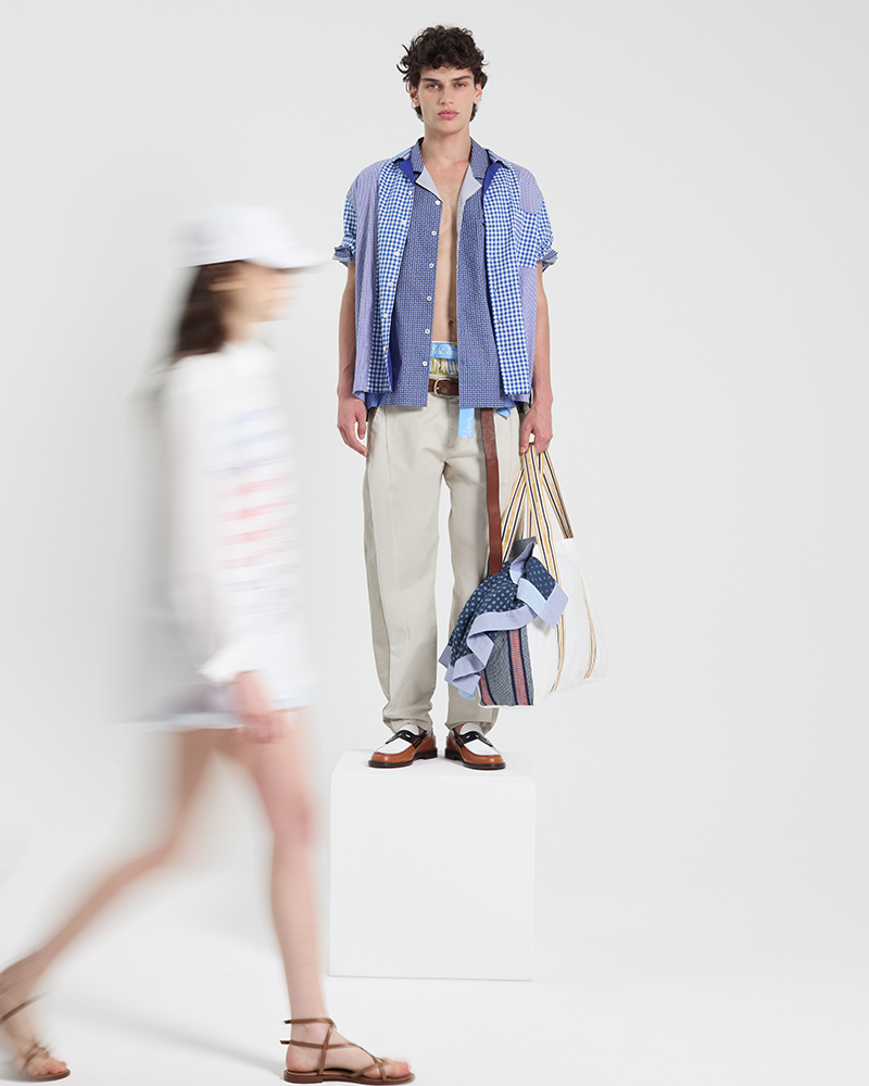 Male model wearing checked shirt and bag from summer collection.