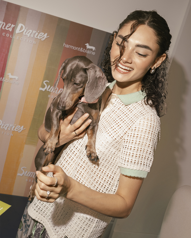 Casual woman with dog at Summer Diaries event.