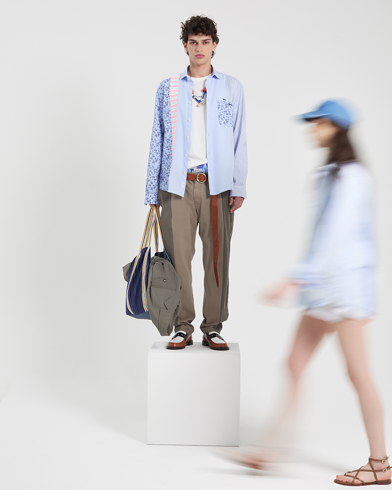 Male model wearing patchwork shirt and bags from summer collection.